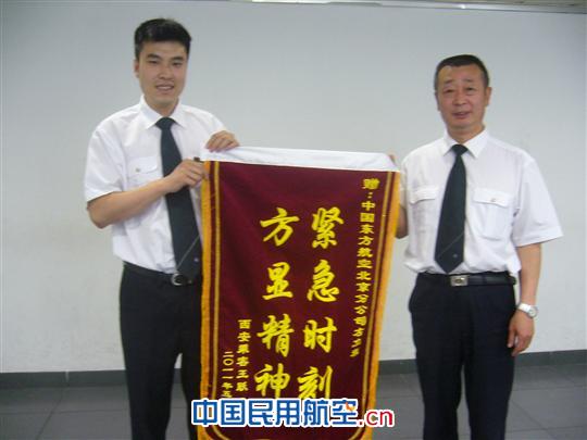 东航北京值班经理左立程(左) 东航北京值班经理左立程帮助旅客顺利乘机